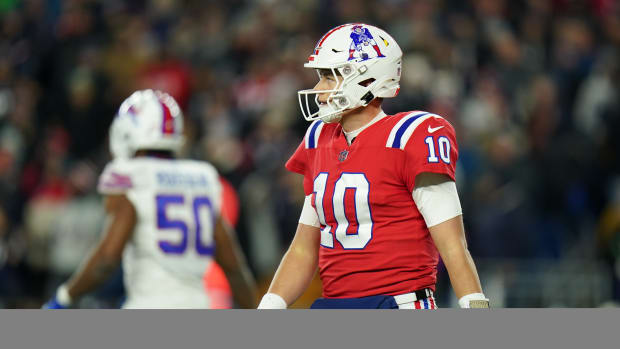 Dec 1, 2022; Foxborough, Massachusetts, USA; New England Patriots quarterback Mac Jones (10) returns to the sideline as they take on the Buffalo Bills in the second quarter at Gillette Stadium.